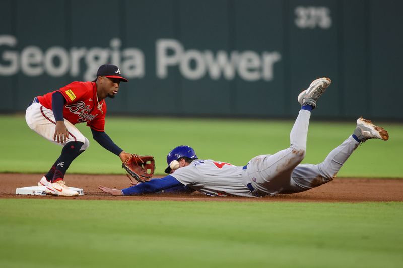 Sep 28, 2023; Atlanta, Georgia, USA; Chicago Cubs center fielder Mike Tauchman (40) steals a base past Atlanta Braves second baseman Ozzie Albies (1) in the first inning at Truist Park. Mandatory Credit: Brett Davis-USA TODAY Sports