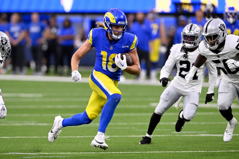 Los Angeles Rams wide receiver Ben Skowronek (18) runs after a catch against the Las Vegas Raiders cornerback Amik Robertson (21) and linebacker Amari Burney, right, during the first half of a preseason NFL football game Saturday, Aug. 19, 2023, in Inglewood, Calif. (AP Photo/Alex Gallardo)