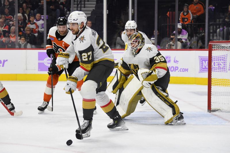 Nov 25, 2024; Philadelphia, Pennsylvania, USA; Vegas Golden Knights defenseman Shea Theodore (27) clears the puck against the Philadelphia Flyers during the first period at Wells Fargo Center. Mandatory Credit: Eric Hartline-Imagn Images