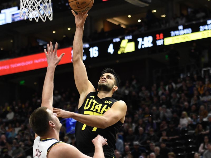 SALT LAKE CITY, UTAH - APRIL 09: Omer Yurtseven #77 of the Utah Jazz shoots over Nikola Jokic #15 of the Denver Nuggets during the first half at Delta Center on April 09, 2024 in Salt Lake City, Utah. NOTE TO USER: User expressly acknowledges and agrees that, by downloading and or using this photograph, User is consenting to the terms and conditions of the Getty Images License Agreement.  (Photo by Alex Goodlett/Getty Images)