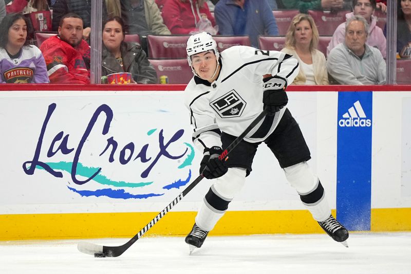 Jan 11, 2024; Sunrise, Florida, USA; Los Angeles Kings defenseman Jordan Spence (21) passes the puck against the Florida Panthers during the first period at Amerant Bank Arena. Mandatory Credit: Jasen Vinlove-USA TODAY Sports