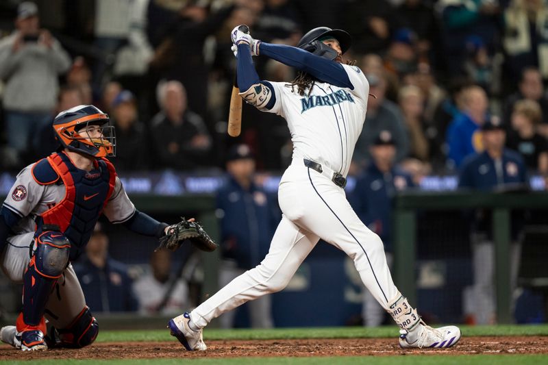 May 29, 2024; Seattle, Washington, USA; Seattle Mariners shortstop J.P. Crawford (3) hits a RBI-sacrifice fly during the tenth inning against the Houston Astros at T-Mobile Park. Mandatory Credit: Stephen Brashear-USA TODAY Sports