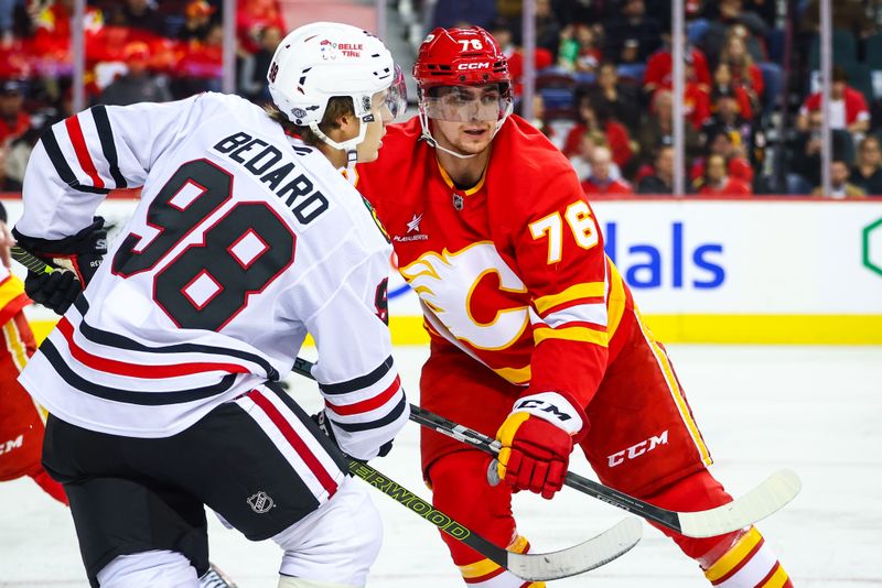 Oct 15, 2024; Calgary, Alberta, CAN; Calgary Flames center Martin Pospisil (76) and Chicago Blackhawks center Connor Bedard (98) battles for the puck during the second period at Scotiabank Saddledome. Mandatory Credit: Sergei Belski-Imagn Images