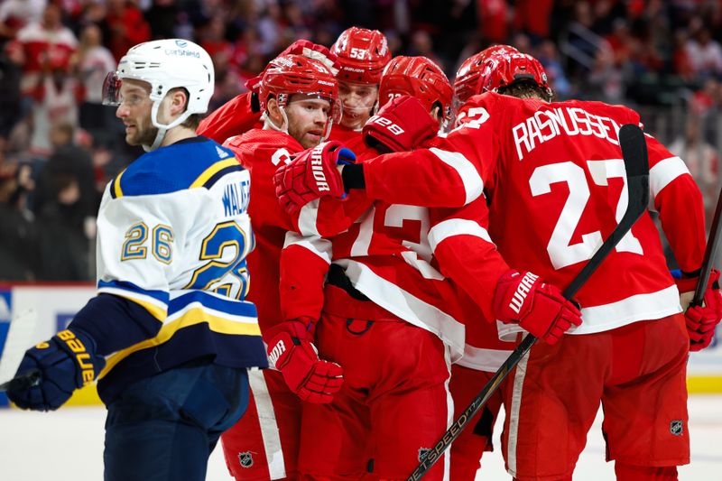 Feb 24, 2024; Detroit, Michigan, USA;  Detroit Red Wings left wing J.T. Compher (37) receives congratulations from teammates after scoring in the second period against the St. Louis Blues at Little Caesars Arena. Mandatory Credit: Rick Osentoski-USA TODAY Sports