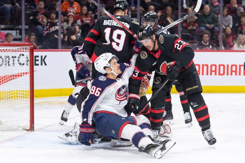 Feb 13, 2024; Ottawa, Ontario, CAN; Columbus Blue Jackets center Jack  Roslovic (96) is taken down by Ottawa Senators defenseman Travis Hamonic (23) in the second period at the Canadian Tire Centre. Mandatory Credit: Marc DesRosiers-USA TODAY Sports