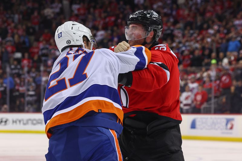 Nov 28, 2023; Newark, New Jersey, USA; New York Islanders left wing Anders Lee (27) and New Jersey Devils defenseman Brendan Smith (2) fight during the third period at Prudential Center. Mandatory Credit: Ed Mulholland-USA TODAY Sports