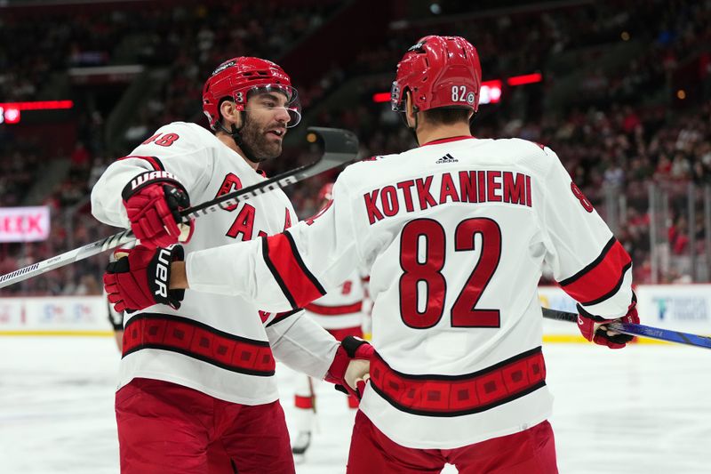 Nov 10, 2023; Sunrise, Florida, USA; Carolina Hurricanes center Jesperi Kotkaniemi (82) celebrates his goal against the Florida Panthers with left wing Jordan Martinook (48) during the first period at Amerant Bank Arena. Mandatory Credit: Jasen Vinlove-USA TODAY Sports