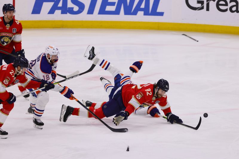 Jun 24, 2024; Sunrise, Florida, USA; Florida Panthers forward Kevin Stenlund (82) is checked by Edmonton Oilers forward Leon Draisaitl (29) as Edmonton Oilers forward Zach Hyman (18) and Florida Panthers forward Eetu Luostarinen (27) watch during the second period in game seven of the 2024 Stanley Cup Final at Amerant Bank Arena. Mandatory Credit: Sam Navarro-USA TODAY Sports