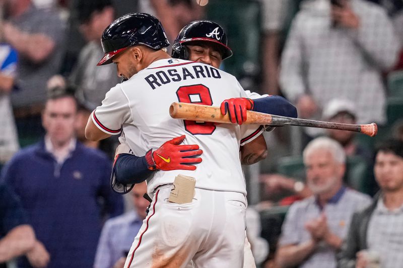 Apr 12, 2023; Cumberland, Georgia, USA; Atlanta Braves left fielder Eddie Rosario (8) reacts with second baseman Ozzie Albies (1) after hitting a home run against the Cincinnati Reds during the eighth inning at Truist Park. Mandatory Credit: Dale Zanine-USA TODAY Sports