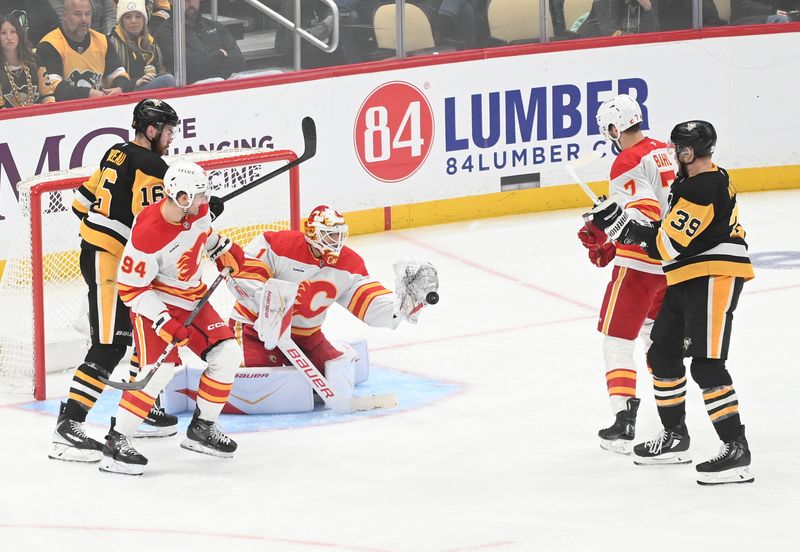 Jan 10, 2026; Pittsburgh, Pennsylvania, USA; Calgary Flames goalie Devin Cooley (1) makes a save under pressure from Pittsburgh Penguins right wing Justin Brazeau (16) and right wing Anthony Mantha (39) during the second period at PPG Paints Arena. Mandatory Credit: Philip G. Pavely-Imagn Images