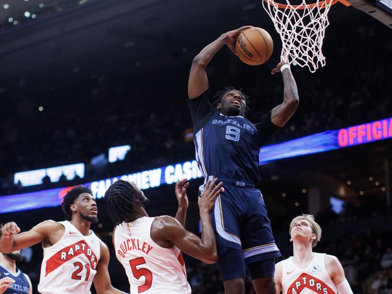 TORONTO, CANADA - JANUARY 22: Vince Williams Jr. #5 of the Memphis Grizzlies grabs a rebound over Thaddeus Young #21, Immanuel Quickley #5 and Gradey Dick #1 of the Toronto Raptors in the second half at Scotiabank Arena on January 22, 2024 in Toronto, Canada. NOTE TO USER: User expressly acknowledges and agrees that, by downloading and or using this photograph, User is consenting to the terms and conditions of the Getty Images License Agreement. (Photo by Cole Burston/Getty Images)