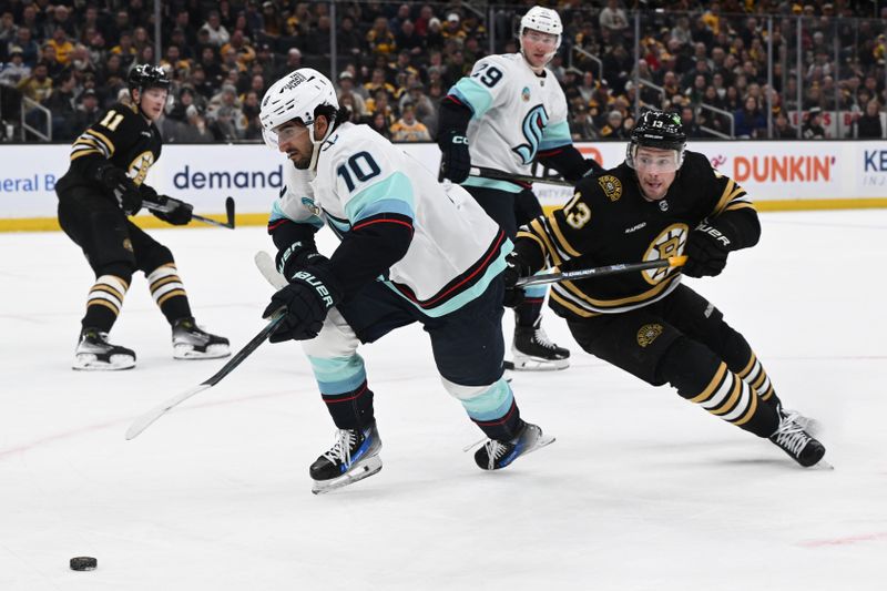 Feb 15, 2024; Boston, Massachusetts, USA; Seattle Kraken center Matty Beniers (10) controls the puck against Boston Bruins center Charlie Coyle (13) during the third period at the TD Garden. Mandatory Credit: Brian Fluharty-USA TODAY Sports