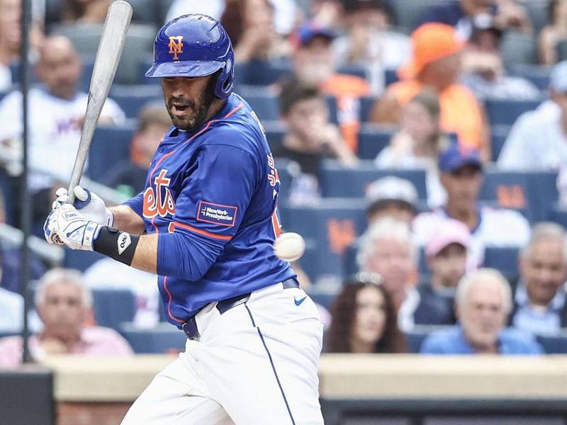 Jun 26, 2024; New York City, New York, USA;  New York Mets designated hitter J.D. Martinez (28) is hit by a pitch in the first inning against the New York Yankees at Citi Field. Mandatory Credit: Wendell Cruz-USA TODAY Sports