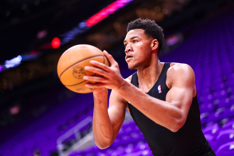 TORONTO, CANADA - OCTOBER 23: Ulrich Chomchie #22 of the Toronto Raptors warms up before the game against the Cleveland Cavaliers on October 23, 2024 at the Scotiabank Arena in Toronto, Ontario, Canada.  NOTE TO USER: User expressly acknowledges and agrees that, by downloading and or using this Photograph, user is consenting to the terms and conditions of the Getty Images License Agreement.  Mandatory Copyright Notice: Copyright 2024 NBAE (Photo by Vaughn Ridley/NBAE via Getty Images)