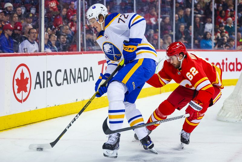 Mar 24, 2024; Calgary, Alberta, CAN; Buffalo Sabres right wing Tage Thompson (72) and Calgary Flames defenseman Daniil Miromanov (62) battles for the puck during the first period at Scotiabank Saddledome. Mandatory Credit: Sergei Belski-USA TODAY Sports