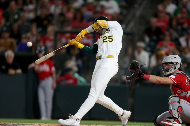 Sep 13, 2025; West Sacramento, California, USA; Athletics designated hitter Brent Rooker (25) hits a solo home run against the Cincinnati Reds during the second inning at Sutter Health Park. Mandatory Credit: Dennis Lee-Imagn Images