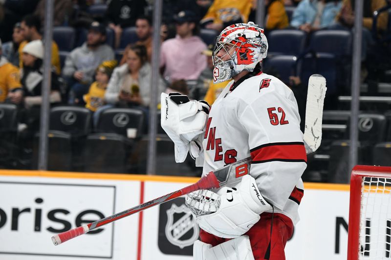 Dec 27, 2023; Nashville, Tennessee, USA; Carolina Hurricanes goaltender Pyotr Kochetkov (52) celebrates after a win against the Nashville Predators at Bridgestone Arena. Mandatory Credit: Christopher Hanewinckel-USA TODAY Sports