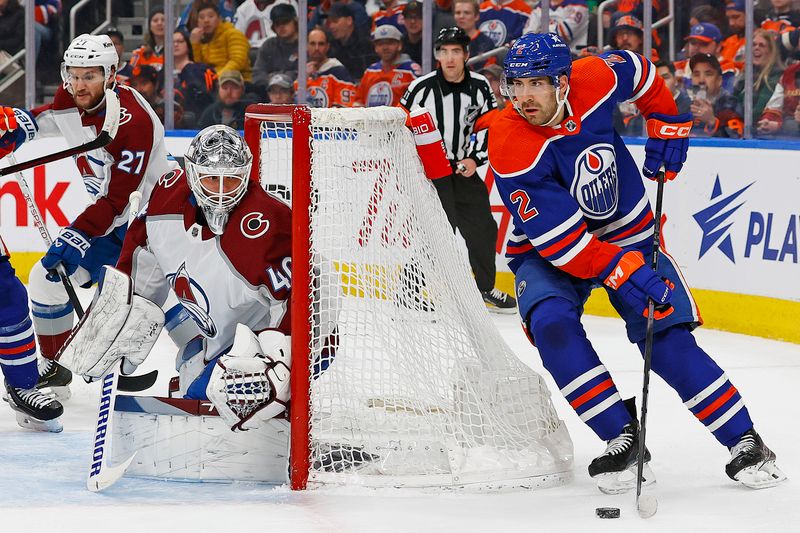 Apr 5, 2024; Edmonton, Alberta, CAN; Edmonton Oilers defensemen Evan Bouchard (2) looks to make a pass from behind Colorado Avalanche goaltender Alexander Georgiev (40) during the first period at Rogers Place. Mandatory Credit: Perry Nelson-USA TODAY Sports