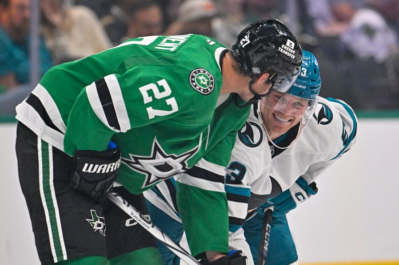 Oct 15, 2024; Dallas, Texas, USA; Dallas Stars left wing Mason Marchment (27) talks with San Jose Sharks center Ty Dellandrea (53) at center ice during the third period at the American Airlines Center. Mandatory Credit: Jerome Miron-Imagn Images