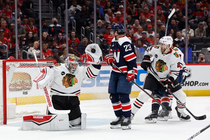 Mar 9, 2024; Washington, District of Columbia, USA; Chicago Blackhawks goaltender Petr Mrazek (34) makes a save in front of Washington Capitals center Michael Sgarbossa (23) in the first period at Capital One Arena. Mandatory Credit: Geoff Burke-USA TODAY Sports