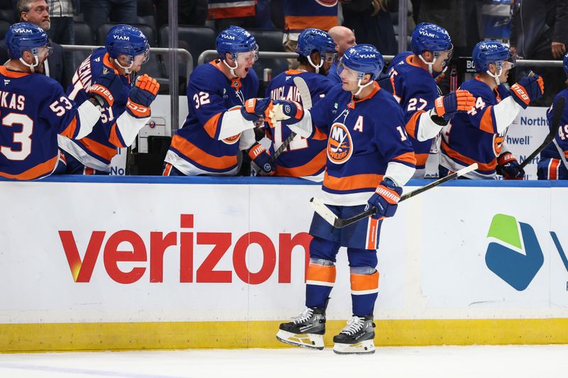 Oct 16, 2025; Elmont, New York, USA; New York Islanders center Bo Horvat (14) celebrates with his teammates after scoring a goal in the third period against the Edmonton Oilers at UBS Arena. Mandatory Credit: Wendell Cruz-Imagn Images