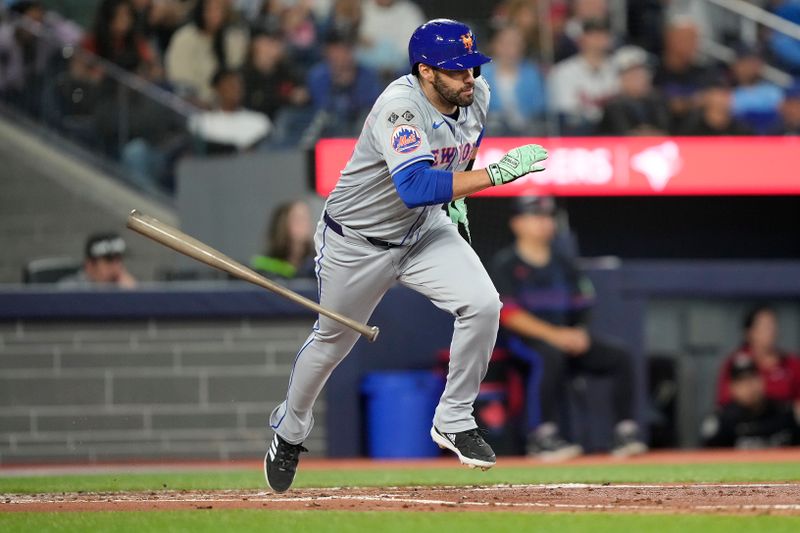 Sep 9, 2024; Toronto, Ontario, CAN; New York Mets designated hitter J.D. Martinez (28) hits a one run single against the Toronto Blue Jays during the fourth inning at Rogers Centre. Mandatory Credit: John E. Sokolowski-Imagn Images