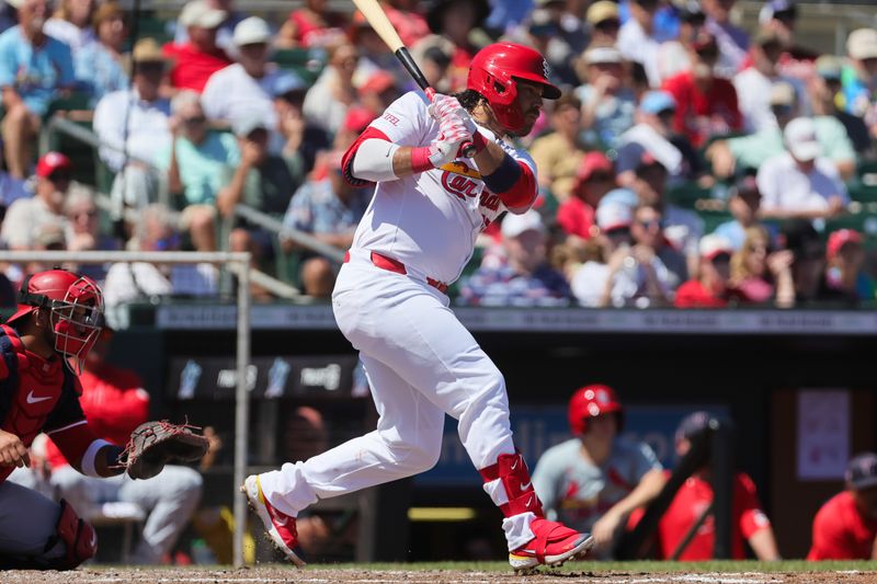 Mar 11, 2024; Jupiter, Florida, USA; St. Louis Cardinals shortstop Brandon Crawford (35) hits a single against the Washington Nationals during the third inning at Roger Dean Chevrolet Stadium. Mandatory Credit: Sam Navarro-USA TODAY Sports