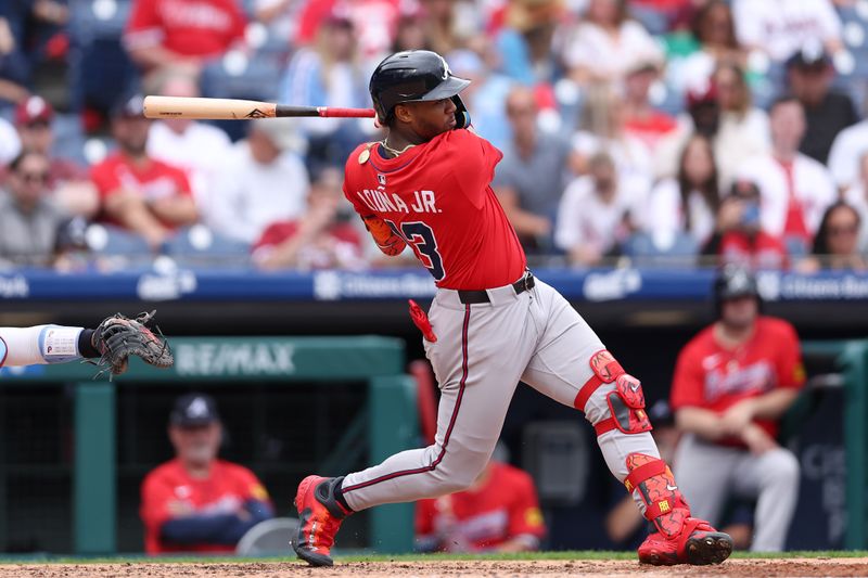 May 29, 2025; Philadelphia, Pennsylvania, USA; Atlanta Braves outfielder Ronald Acuña Jr. (13) hits an RBI single during the sixth inning against the Philadelphia Phillies at Citizens Bank Park. Mandatory Credit: Bill Streicher-Imagn Images