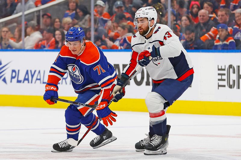 Mar 13, 2024; Edmonton, Alberta, CAN; Edmonton Oilers forward Ryan McLeod (71) and Washington Capitals forward Tom Wilson (43) battle for a loose puck  during the first period at Rogers Place. Mandatory Credit: Perry Nelson-USA TODAY Sports