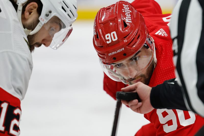 Jan 31, 2024; Detroit, Michigan, USA;  Detroit Red Wings center Joe Veleno (90) and Ottawa Senators center Mark Kastelic (12) gets set to face off in the second period at Little Caesars Arena. Mandatory Credit: Rick Osentoski-USA TODAY Sports