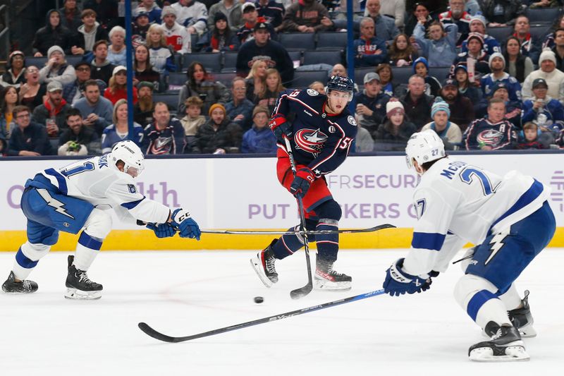 Nov 21, 2024; Columbus, Ohio, USA; Columbus Blue Jackets right wing Yegor Chinakhov (59) passes the puck as Tampa Bay Lightning defenseman Ryan McDonagh (27) defends during the second period at Nationwide Arena. Mandatory Credit: Russell LaBounty-Imagn Images