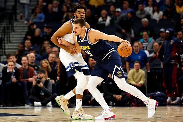 MINNEAPOLIS, MINNESOTA - NOVEMBER 01: Nikola Jokic #15 of the Denver Nuggets drives to the basket while Karl-Anthony Towns #32 of the Minnesota Timberwolves defends in the first quarter at Target Center on November 01, 2023 in Minneapolis, Minnesota. The Timberwolves defeated the Nuggets 110-89. NOTE TO USER: User expressly acknowledges and agrees that, by downloading and or using this photograph, User is consenting to the terms and conditions of the Getty Images License Agreement. (Photo by David Berding/Getty Images)