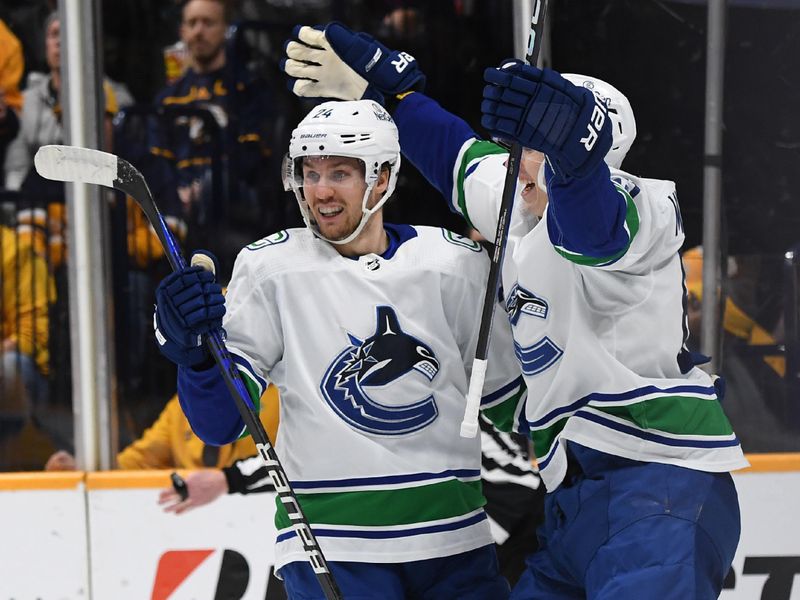 Dec 19, 2023; Nashville, Tennessee, USA; Vancouver Canucks center Pius Suter (24) celebrates after a goal during the second period against the Nashville Predators at Bridgestone Arena. Mandatory Credit: Christopher Hanewinckel-USA TODAY Sports