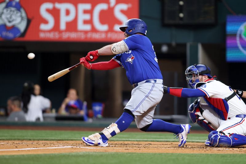 May 26, 2025; Arlington, Texas, USA; Toronto Blue Jays catcher Alejandro Kirk (30) hits a sacrifice fly during the fourth inning against the Texas Rangers at Globe Life Field. Mandatory Credit: Tim Heitman-Imagn Images
