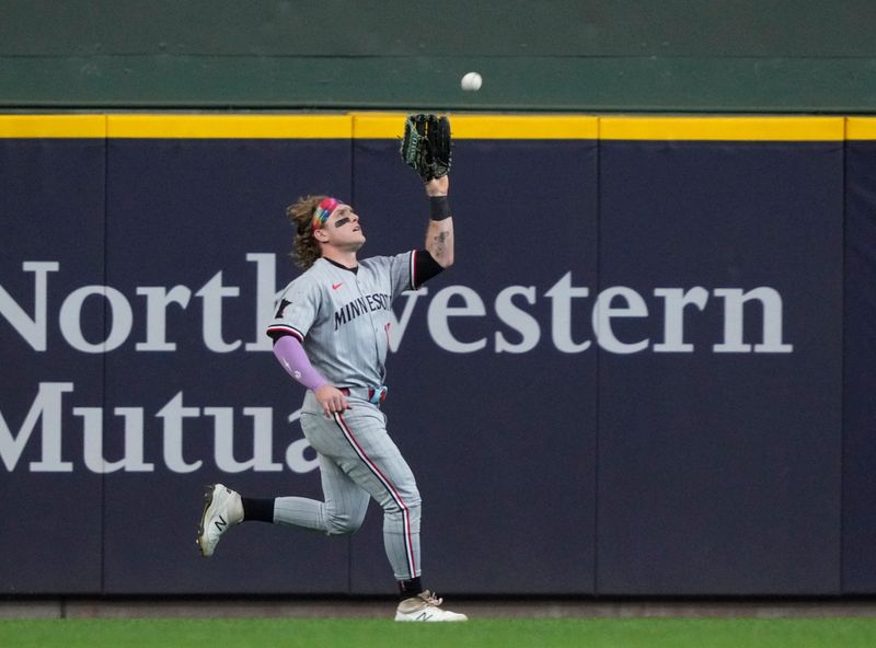 May 18, 2025; Milwaukee, Wisconsin, USA: Minnesota Twins outfielder Harrison Bader (12) catches a fly ball against the Milwaukee Brewers in the eighth inning at American Family Field. Mandatory Credit: Michael McLoone-Imagn Images