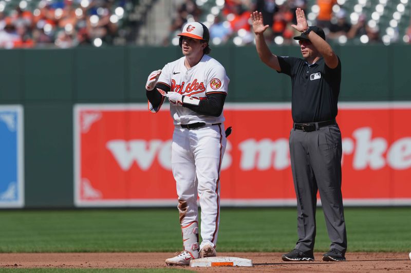 Sep 19, 2024; Baltimore, Maryland, USA; Baltimore Orioles catcher Adley Rutschman (35) drives in a run on his fourth inning double against the San Francisco Giants at Oriole Park at Camden Yards. Mandatory Credit: Mitch Stringer-Imagn Images