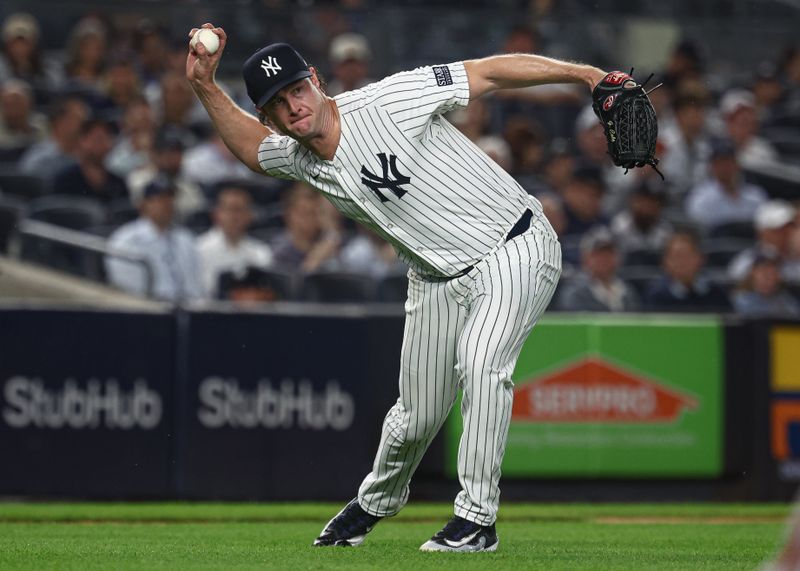 Sep 26, 2024; Bronx, New York, USA; New York Yankees starting pitcher Gerrit Cole (45) throws the ball to first base for an out during the fourth inning against the Baltimore Orioles at Yankee Stadium. Mandatory Credit: Vincent Carchietta-Imagn Images