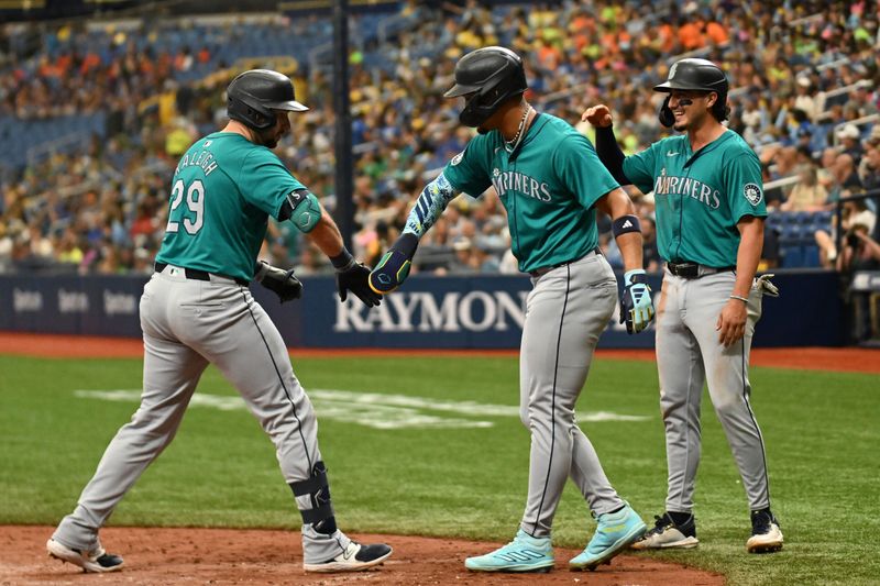 Jun 26, 2024; St. Petersburg, Florida, USA; Seattle Mariners designated hitter Cal Raleigh (29) celebrates with third baseman Josh Rojas (4) and center fielder Julio Rodriquez (44) after hitting a three run home run against the Tampa Bay Rays in the sixth inning at Tropicana Field. Mandatory Credit: Jonathan Dyer-USA TODAY Sports