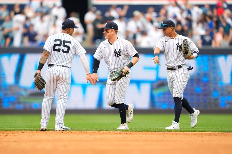 Jul 8, 2023; Bronx, New York, USA; New York Yankees second baseman Gleybor Torres (25) and center fielder Harrison Bader (22) celebrate along with third baseman Oswaldo Cabrera (95) after the game against the Chicago Cubs at Yankee Stadium. Mandatory Credit: Gregory Fisher-USA TODAY Sports