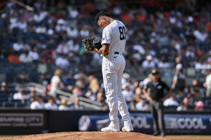 Jun 20, 2024; Bronx, New York, USA; New York Yankees pitcher Luis Gil (81) checks his cap during the second inning against the Baltimore Orioles at Yankee Stadium. Mandatory Credit: John Jones-USA TODAY Sports