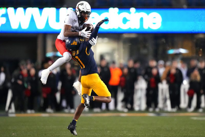 Nov 18, 2023; Morgantown, West Virginia, USA; Cincinnati Bearcats wide receiver Xzavier Henderson (8) is unable to catch a pass against West Virginia Mountaineers cornerback Beanie Bishop Jr. (11) in the fourth quarter at Milan Puskar Stadium. West Virginia won 42-21. Mandatory Credit: Kareem Elgazzar-USA TODAY Sports