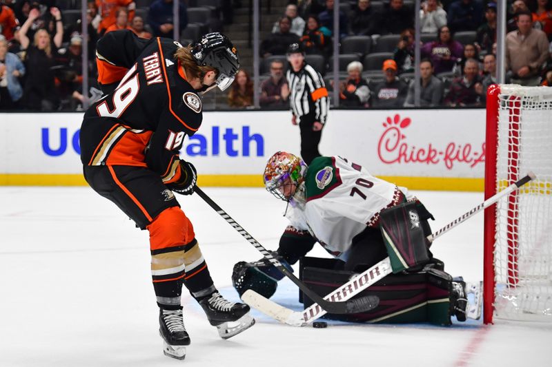 Nov 1, 2023; Anaheim, California, USA; Arizona Coyotes goaltender Karel Vejmelka (70) blcoks a shot against Anaheim Ducks right wing Troy Terry (19) during the third period at Honda Center. Mandatory Credit: Gary A. Vasquez-USA TODAY Sports