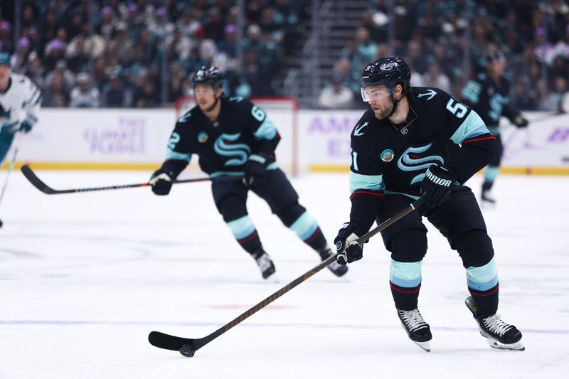 Nov 15, 2025; Seattle, Washington, USA; Seattle Kraken defenseman Ryker Evans (41) controls the puck in the first period against the San Jose Sharks at Climate Pledge Arena. Mandatory Credit: Kevin Ng-Imagn Images