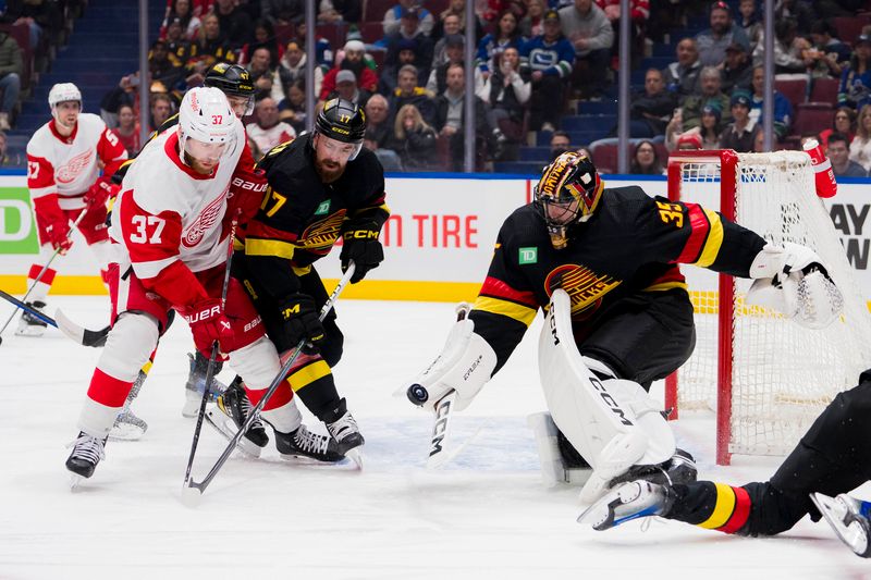 Feb 15, 2024; Vancouver, British Columbia, CAN;  Detroit Red Wings forward J.T. Compher (37) battles with Vancouver Canucks defenseman Filip Hronek (17) as goalie Thatcher Demko (35) makes a save in the first period at Rogers Arena. Mandatory Credit: Bob Frid-USA TODAY Sports