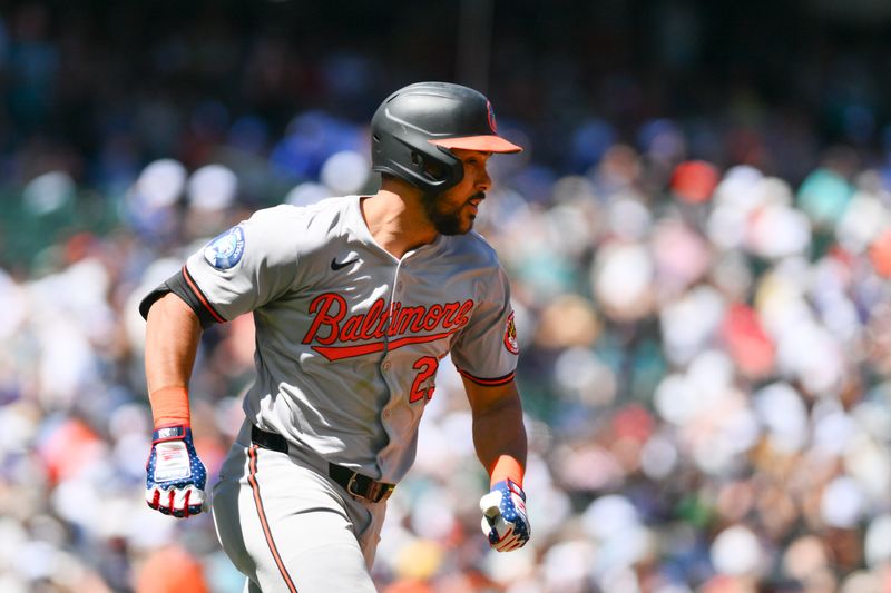 Jul 4, 2024; Seattle, Washington, USA; Baltimore Orioles right fielder Anthony Santander (25) runs towards first base after hitting a single against the Seattle Mariners during the third inning at T-Mobile Park. Mandatory Credit: Steven Bisig-USA TODAY Sports
