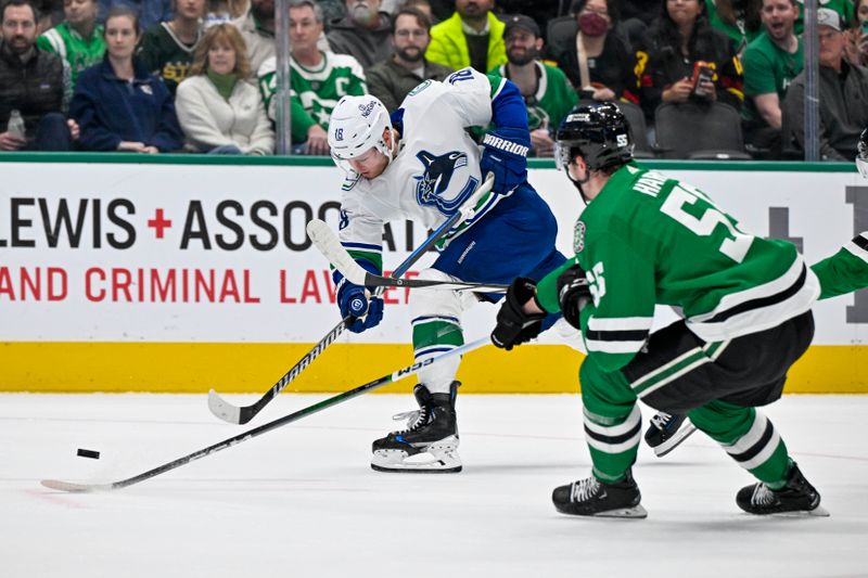 Dec 21, 2023; Dallas, Texas, USA; Vancouver Canucks center Sam Lafferty (18) shoots the puck past Dallas Stars defenseman Thomas Harley (55) during the first period at the American Airlines Center. Mandatory Credit: Jerome Miron-USA TODAY Sports