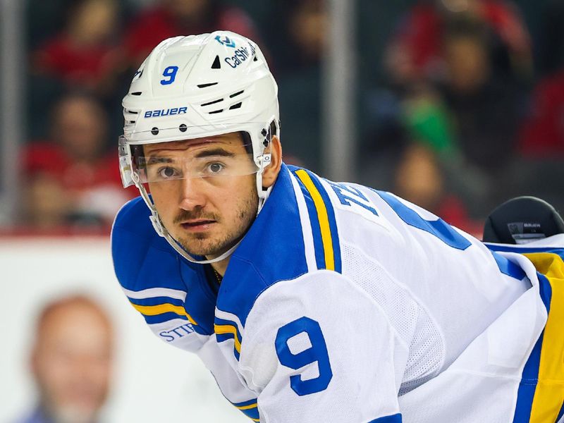 Oct 11, 2025; Calgary, Alberta, CAN; St. Louis Blues left wing Alexandre Texier (9) during the face off against the Calgary Flames during the first period at Scotiabank Saddledome. Mandatory Credit: Sergei Belski-Imagn Images