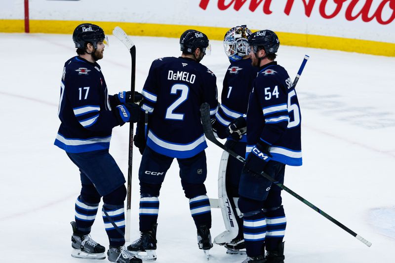 Jan 20, 2026; Winnipeg, Manitoba, CAN; Winnipeg Jets goalie Eric Comrie (1) is congratulated by his team mates on his win against the St. Louis Blues at the end of the third period at Canada Life Centre. Mandatory Credit: Terrence Lee-Imagn Images Jan 20, 2026; Winnipeg, Manitoba, CAN; Winnipeg Jets goalie Eric Comrie (1) is congratulated by his team mates on his win against the St. Louis Blues at the end of the third period at Canada Life Centre. Mandatory Credit: Terrence Lee-Imagn Images