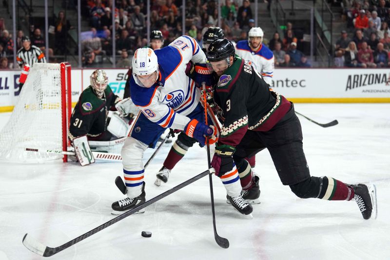 Feb 19, 2024; Tempe, Arizona, USA; Edmonton Oilers left wing Zach Hyman (18) and Arizona Coyotes defenseman Josh Brown (3) battle for the puck during the second period at Mullett Arena. Mandatory Credit: Joe Camporeale-USA TODAY Sports