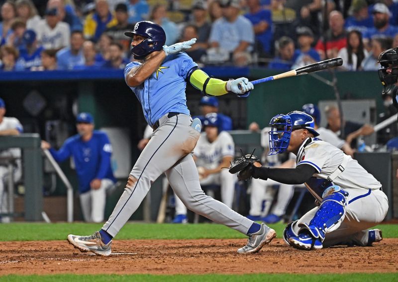 Jul 3, 2024; Kansas City, Missouri, USA;  Tampa Bay Rays third baseman Amed Rosario (10) doubles in a run in the eighth inning against the Kansas City Royals at Kauffman Stadium. Mandatory Credit: Peter Aiken-USA TODAY Sports